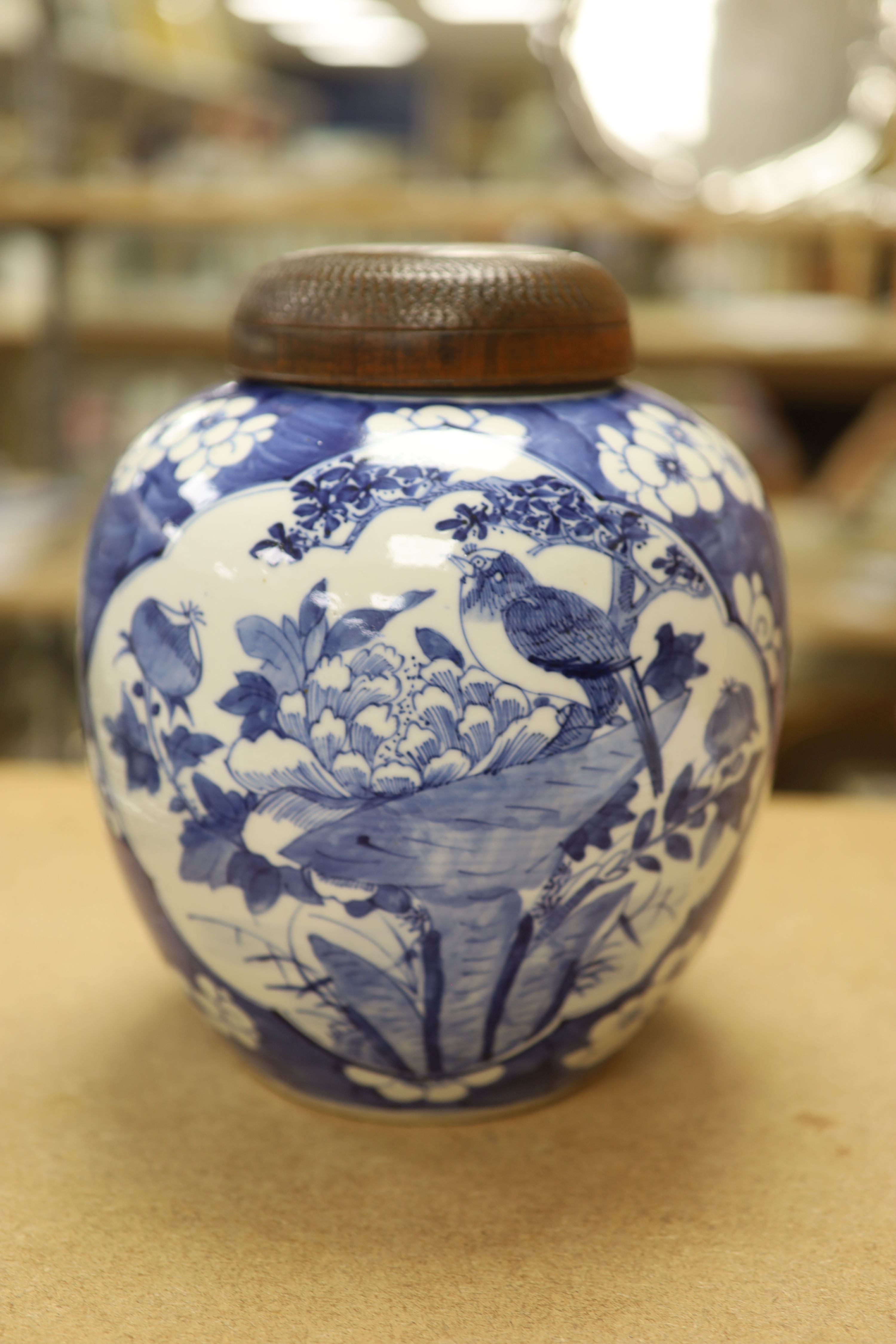 A late 19th / early 20th century Chinese blue and white jar, with wooden cover, height 25cm
